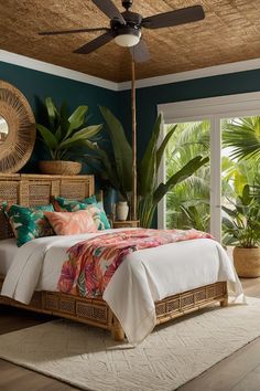 a bedroom with a bed, ceiling fan and large windows in the room that overlooks palm trees