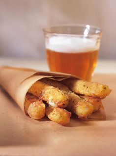 some food and a drink on a table with a brown paper bag next to it