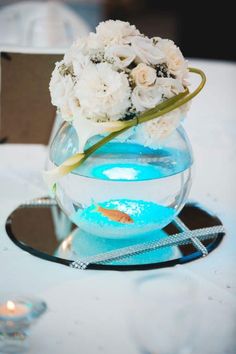 a vase filled with white flowers sitting on top of a table