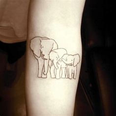 an elephant family tattoo on the arm