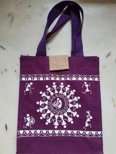 a purple bag with white designs on it