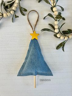 an ornament made out of blue jeans with a yellow star on the top