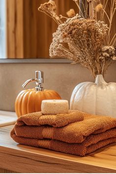 towels and pumpkins are sitting on the counter