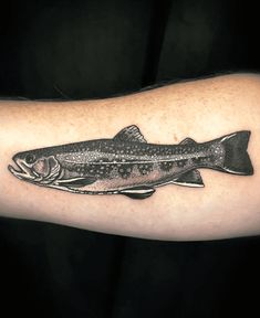 a black and white photo of a fish on the arm