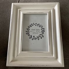 a white frame with a wreath on it