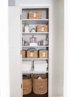 an organized pantry with baskets and toilet paper