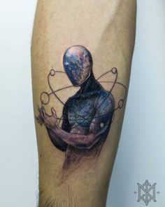 a man's arm with a tattoo on it that has an image of a person holding