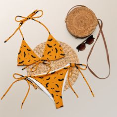 Stay comfortable and stylish all summer with this All-Over Print Recycled String Bikini set. It’s made from soft recycled polyester with double-layering and UPF 50+. Style the straps how you like, and get ready to swim! • Soft and stretchy material with UPF 50+ • Sizes up to 6XL • Bikini top comes with removable padding for comfort • Multiple ways to tie and style the bikini set • Color design options for swimwear lining Disclaimers: • Due to the 2-layered construction and internal stitching, a visible stitch may appear in the crotch seam of the bikini bottom. This is a normal part of the manufacturing process and does not impact the quality or performance of the product. • To make your All-Over Print Recycled String Bikini last longer, thoroughly rinse it off after each use and get rid of Orange Nylon Swimwear For Vacation, Summer Vacation Nylon Tankini, Adjustable Tankini For Summer Swimming, Orange Triangle Top Swimwear, Orange Triangle Top Swimwear In Nylon, Orange Nylon Triangle Top Swimwear, Orange Nylon Swimwear, Casual Nylon Swimwear For Sunbathing, Summer Swimwear With Stretch And Adjustable Straps