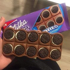 a person holding an oreo chocolate bar in their hand