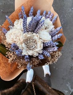 a bouquet of flowers sitting on top of a brown bag