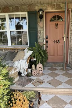 the front porch is decorated for halloween with pumpkins