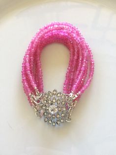 Gorgeous hot pink Quartz bracelet with 8 strands. Finished with an antique like crystal clasp. This is 6 inches in length. My pictures are not of the greatest quality, I use my iPhone (big surprise!)  As I only make 1 of a kind pieces it is obviously very convenient and cost effective. What I can tell you is that I use really nice quality jewels. 98% of my stones are natural and untreated. I have stones that have been glass filled and/or heated. I really prefer not using these but some of these Pink Quartz Bracelet, Multi Strand Bracelet, My Iphone, Strand Bracelet, Quartz Bracelet, Quartz Rose, Pink Quartz, Multi Strand, Arm Band