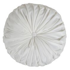 a white round pillow sitting on top of a table