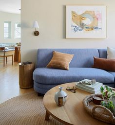 a living room with a blue couch and coffee table