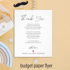 a thank card with a moustache on it next to other items and paper