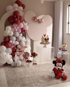 a room with balloons and minnie mouse decorations