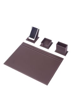 three pieces of brown leather sitting on top of a white surface with cell phone holders