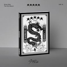 a black and white photo of a dragon playing card with five stars on the side