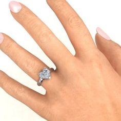 a woman's hand with a diamond ring on it