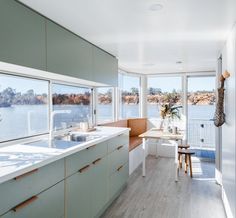 an image of a kitchen with white cabinets and wood flooring on the bottom right hand corner