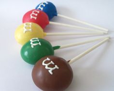 six chocolate lollipops with the word cake on them are arranged in different colors