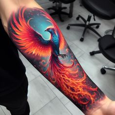 a person with a tattoo on their arm holding a fire bird in the middle of his arm