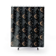 a shower curtain with an image of the moon and stars in black, gold and white