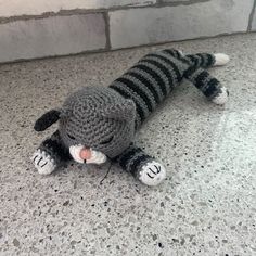 a crocheted stuffed animal laying on the ground