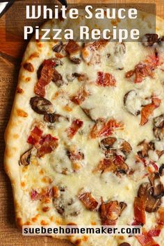 a white sauce pizza with bacon and cheese