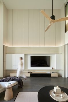 a living room filled with furniture and a flat screen tv on top of a wall