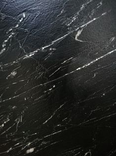 black marble with white streaks on it