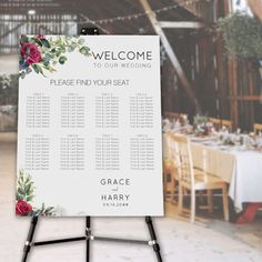 a wedding seating sign with flowers on it in front of a table set for an event