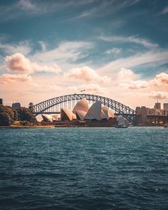 the sydney opera house and harbour bridge are seen from across the water