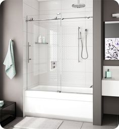 a bathroom with a walk in shower next to a white sink and mirror on the wall