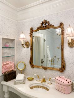 a bathroom sink with a mirror above it and other items on the counter in front of it