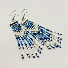 These beaded fringe earrings are fun, flirty, fabulous! I made them with vibrant glass delica beads in tones of navy, cool blue, and transparent blue; and combined them with silver tone bugle and cube beads. They certainly make a statement, a beautiful one at that. Add a touch of glamour to your ensemble with these stunning Art Deco inspired beaded fringe earrings in silver and navy. The intricate beadwork and elegant fringe cascade beautifully, catching the light with every movement. They will move with you, dance with you, and will add sparkle and joy to your day!  These statement earrings are the perfect accessory for any special occasion or evening out. Elevate your style and make a bold statement with these exquisite earrings that effortlessly blend vintage charm with modern sophistic Unique Beaded Fringe Jewelry As Gift, Unique Beaded Fringe Jewelry For Gift, Nickel Free Czech Glass Beaded Earrings For Party, Nickel-free Czech Glass Beaded Earrings For Parties, Silver Adjustable Earrings With Beaded Fringe, Adjustable Beaded Fringe Jewelry Gift, Adjustable Beaded Fringe Jewelry As Gift, Czech Glass Beaded Dangle Earrings For Party, Unique Adjustable Beaded Fringe Earrings