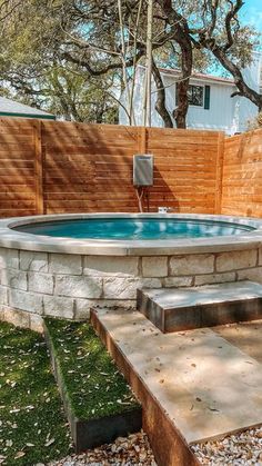 a hot tub sitting in the middle of a yard