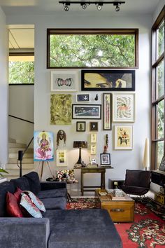 a living room filled with furniture and pictures on the wall