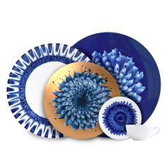 blue and white plates with gold accents on them