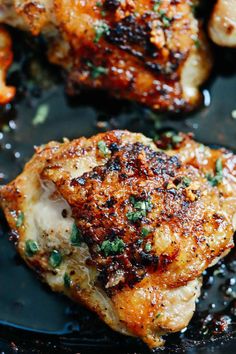 some chicken is cooking in a skillet on the stove with seasoning and spices