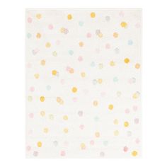 a white rug with multicolored polka dots on the bottom and yellow, blue, pink