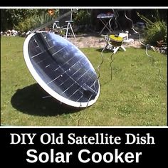 an old satellite dish solar cooker in the grass