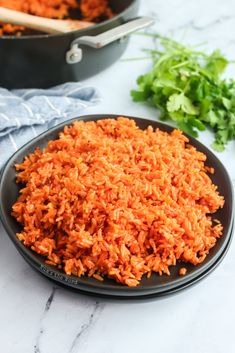 cooked rice in a black bowl on a marble counter