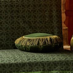 two green pillows sitting on top of a green couch