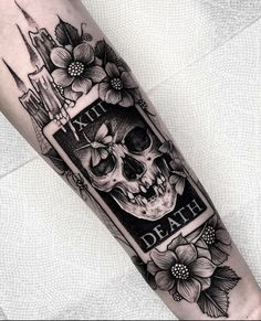 a black and white tattoo with a skull on it