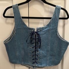 Denim Laced Corset Top With Lace Up Front And A Full Zip Back. Denim Festival Crop Top, Blue Denim Cropped Crop Top, Fitted Denim Crop Top, Casual Style, Denim Top For Festivals, Casual Fitted Denim Crop Top, Fitted Casual Denim Top For Festival, High Rise Denim Crop Top Casual Style, Blue Denim Crop Top For Spring, Casual Medium Wash Denim Top For Festival