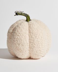 a white wool pumpkin sitting on top of a table