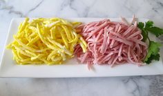 two different types of noodles on a white plate