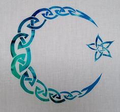 a white t - shirt with a blue crescent and stars on it, in the shape of a circle