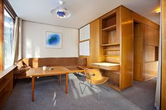 a room with a couch, desk and shelves